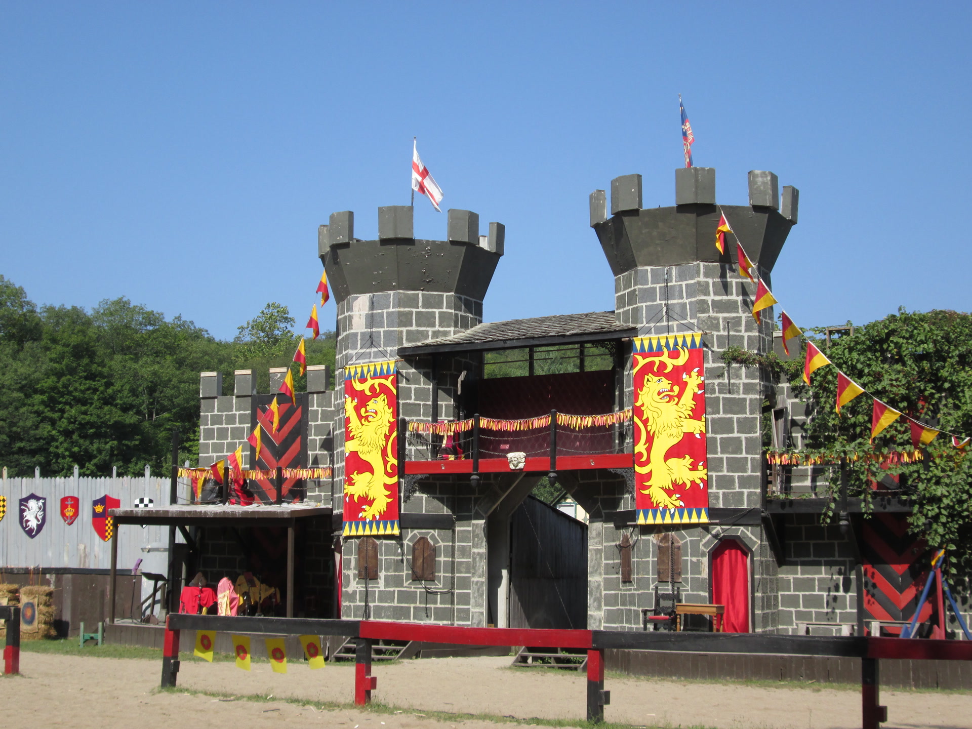 Renaissance faire arena with castle backdrop and costumed attendees